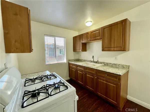 a kitchen with stainless steel appliances granite countertop a stove sink and cabinets