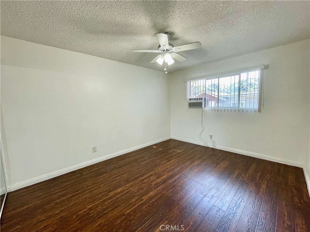 935 East Rte 66 Glendora, CA 91740 - Photo 7 of 10 an empty room with wooden floor fan and windows