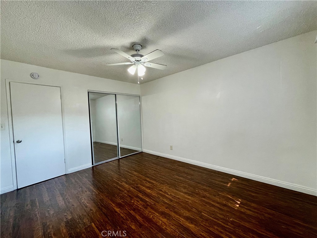 935 East Rte 66 Glendora, CA 91740 - Photo 8 of 10 an empty room with wooden floor and fan