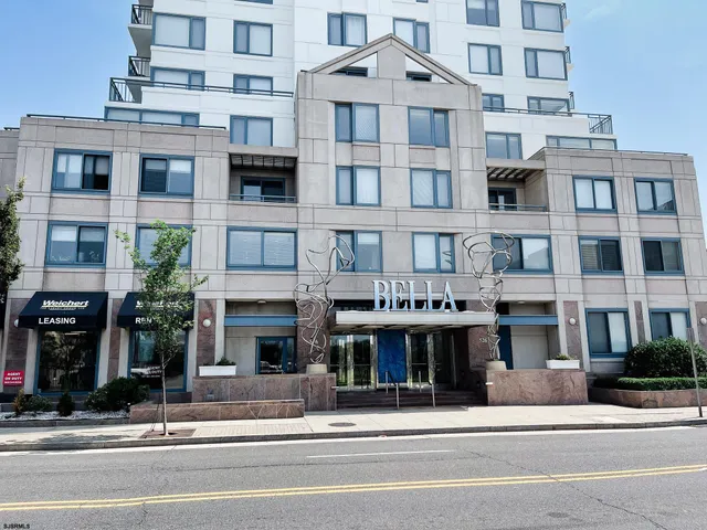 a front view of a building with a garden