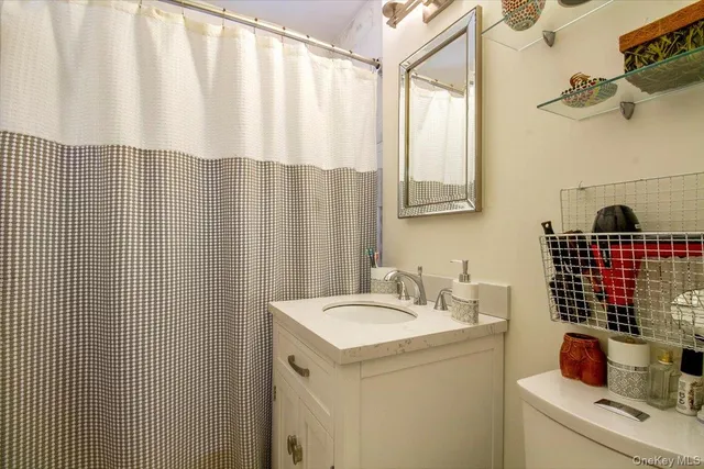 a bathroom with a sink and a shower curtain