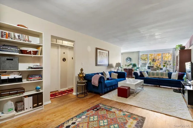 a living room with furniture fireplace and a window