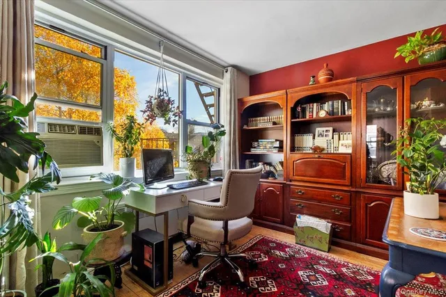 a living room filled with furniture and a floor to ceiling window