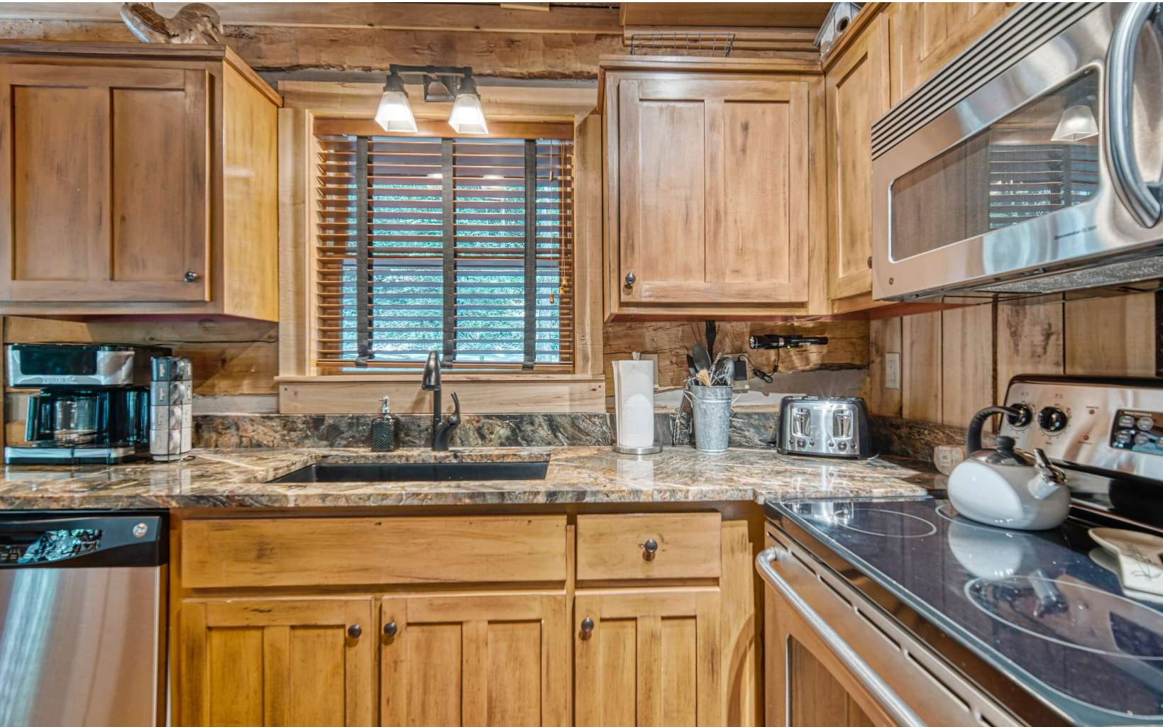 889 Joann Sisson Road Blue Ridge, GA 30513 - Photo 17 of 41 a kitchen with stainless steel appliances granite countertop a sink a stove and cabinets