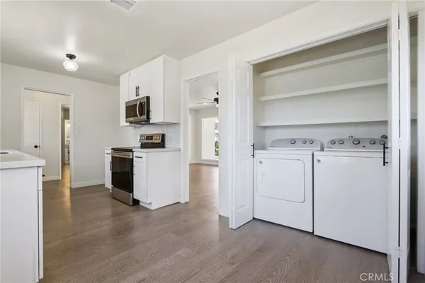 a kitchen with white cabinets and white appliances