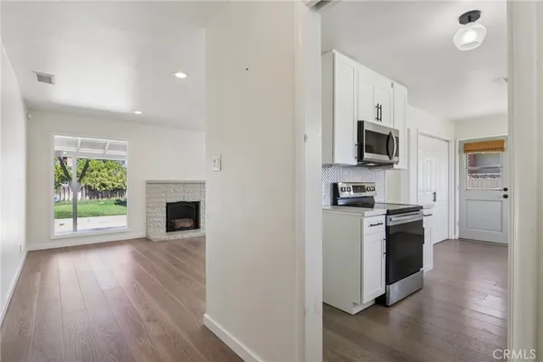 a kitchen with a stove a sink and a microwave
