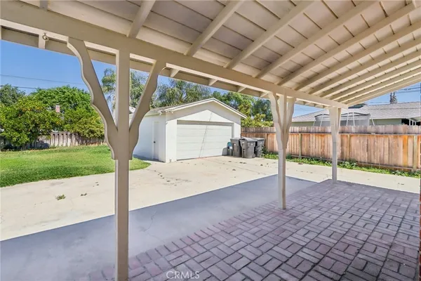a view of a house with a backyard and a patio