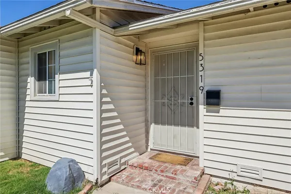 a view of a house with a door and a window