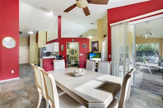 a bedroom with a bed a window and a chandelier