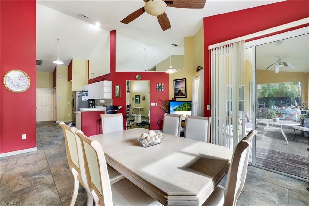 1920 Piccadilly Circus Naples, FL 34112 - Photo 14 of 25 a view of a dining room with furniture wooden floor and chandelier