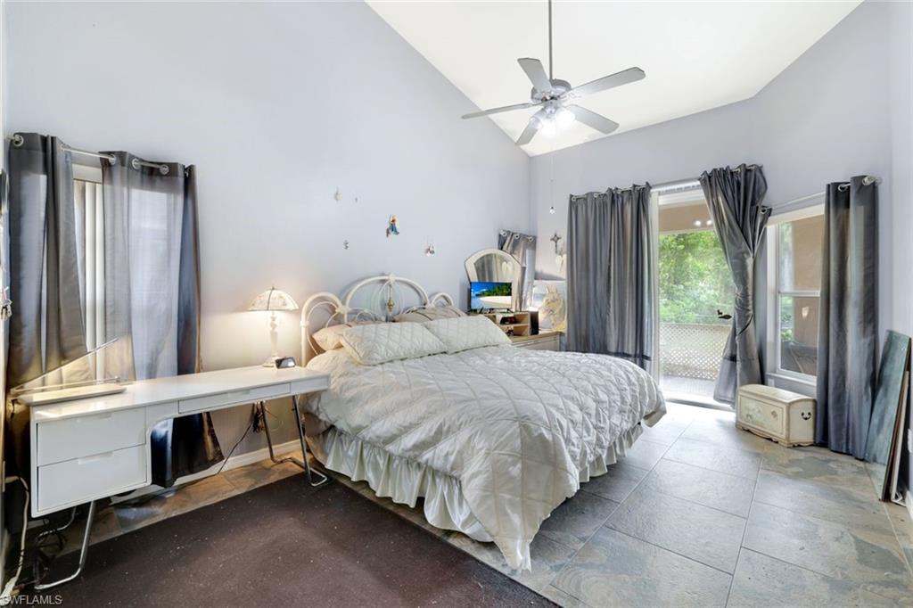 1920 Piccadilly Circus Naples, FL 34112 - Photo 15 of 25 a bedroom with a bed a window and a chandelier