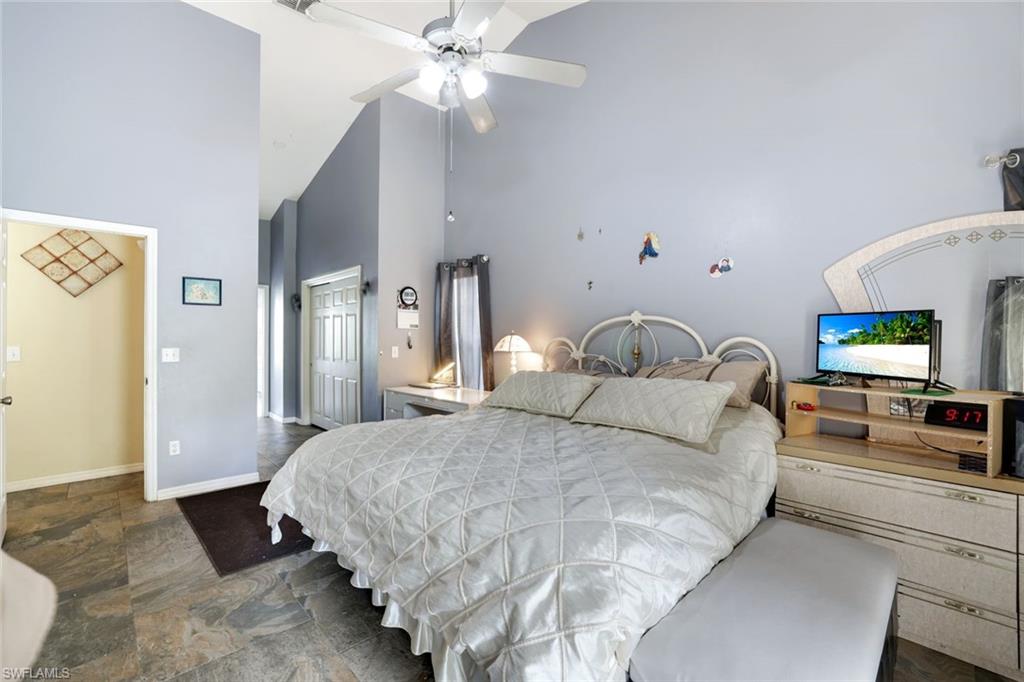 1920 Piccadilly Circus Naples, FL 34112 - Photo 16 of 25 a bedroom with a bed and a chandelier