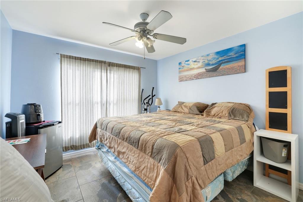 1920 Piccadilly Circus Naples, FL 34112 - Photo 19 of 25 a bedroom with a bed and a chandelier