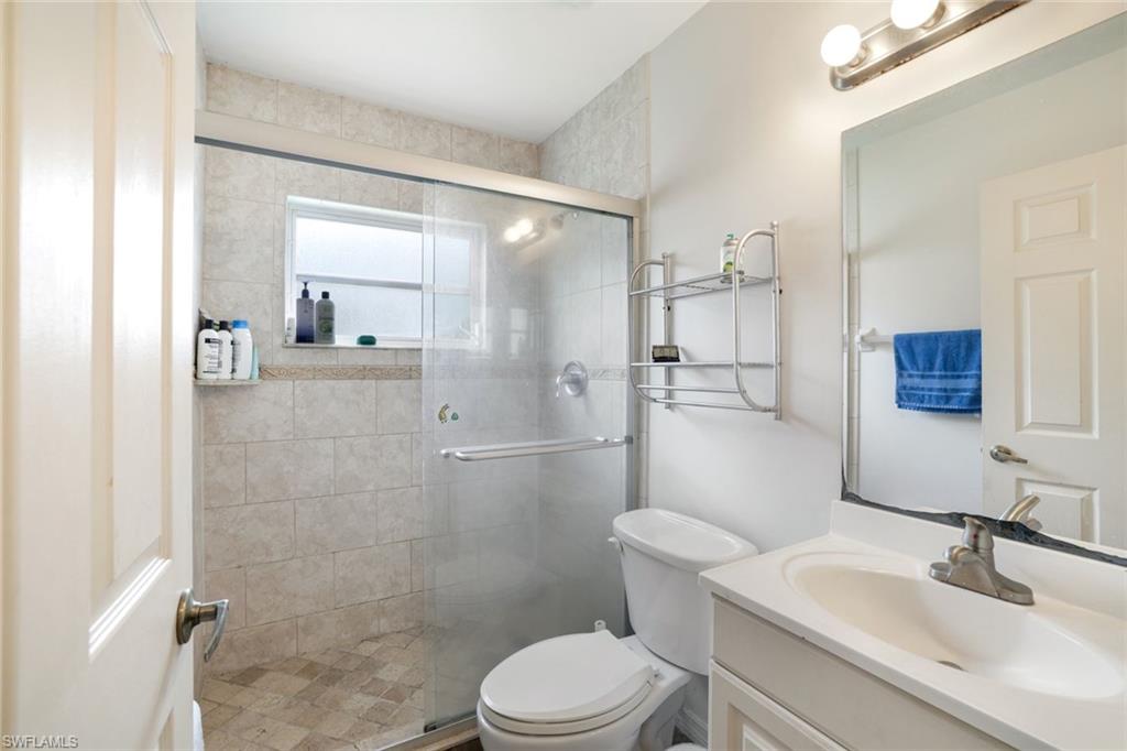 1920 Piccadilly Circus Naples, FL 34112 - Photo 20 of 25 a bathroom with a sink a toilet and shower