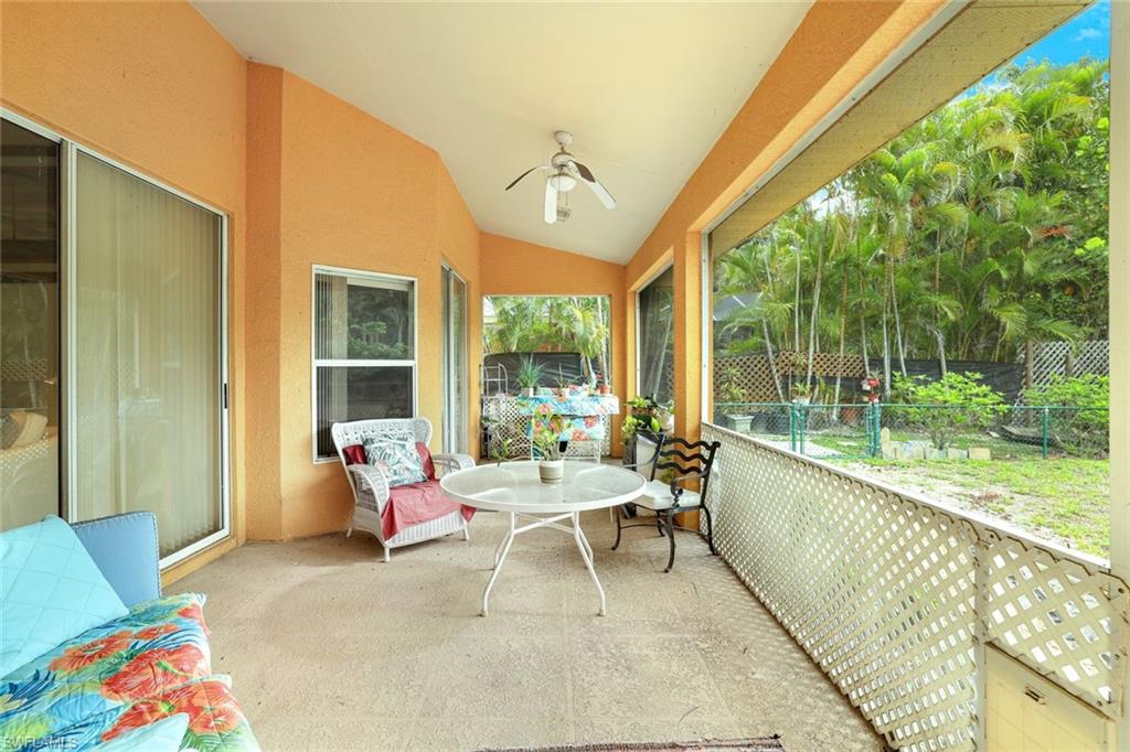 1920 Piccadilly Circus Naples, FL 34112 - Photo 22 of 25 a balcony with furniture and a large window