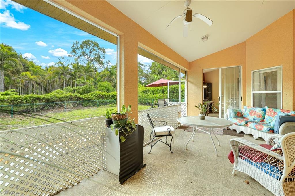 1920 Piccadilly Circus Naples, FL 34112 - Photo 23 of 25 a living room with patio furniture and a floor to ceiling window