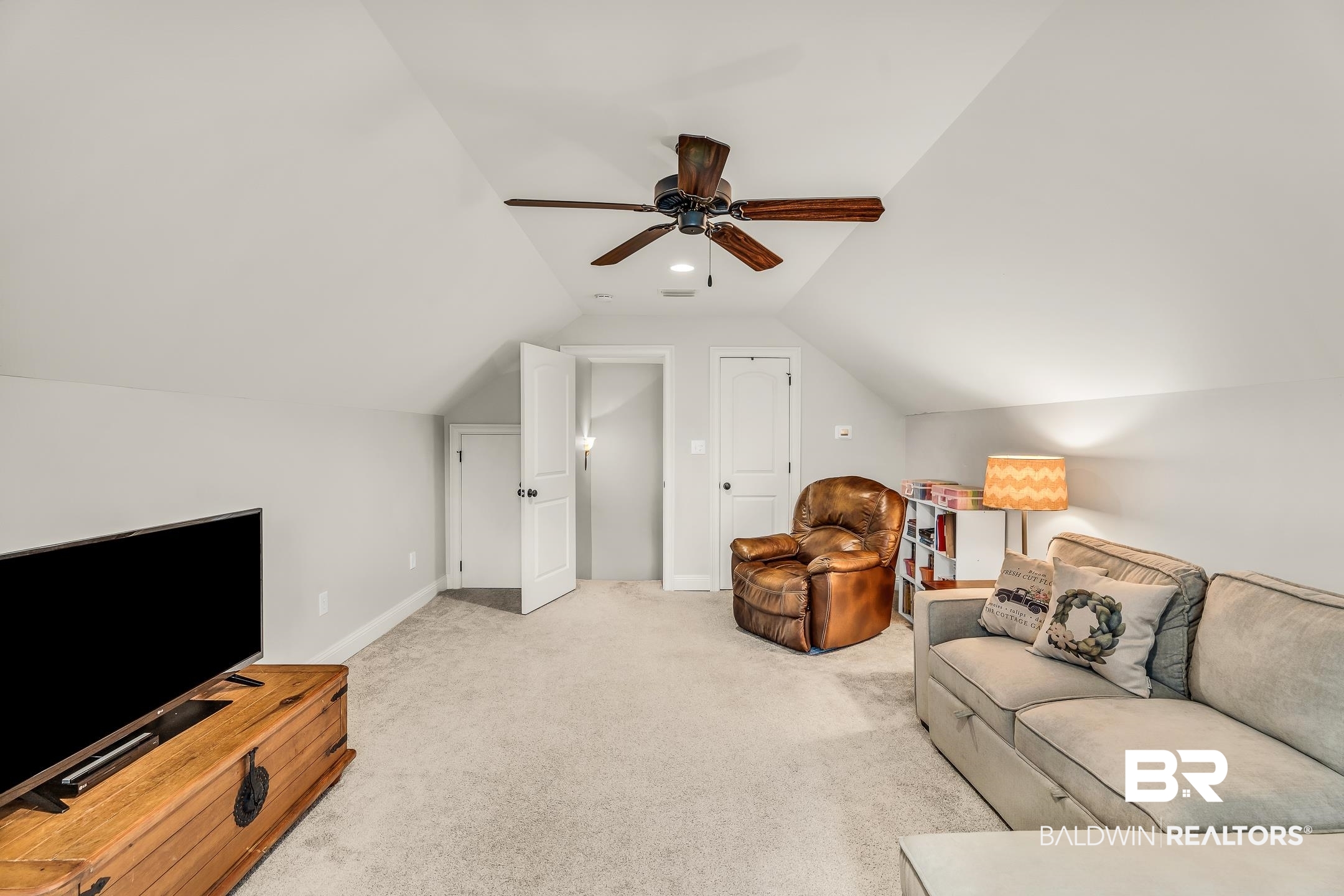 7696 Raegan Lane Daphne, AL 36527 - Photo 30 of 41 Carpeted living room with ceiling fan and lofted ceiling