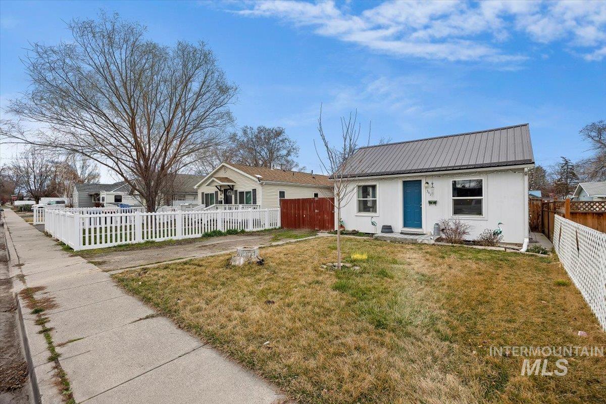 347 Polk Street Twin Falls, ID 83301 - Photo 2 of 25 View of front of property with a fenced front yard and a metal roof