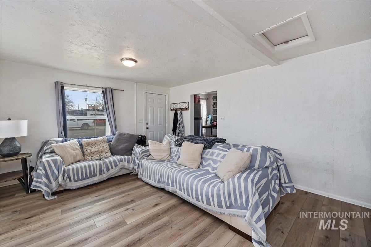 347 Polk Street Twin Falls, ID 83301 - Photo 7 of 25 Living area with a textured ceiling, a textured wall, and hardwood / wood-style flooring