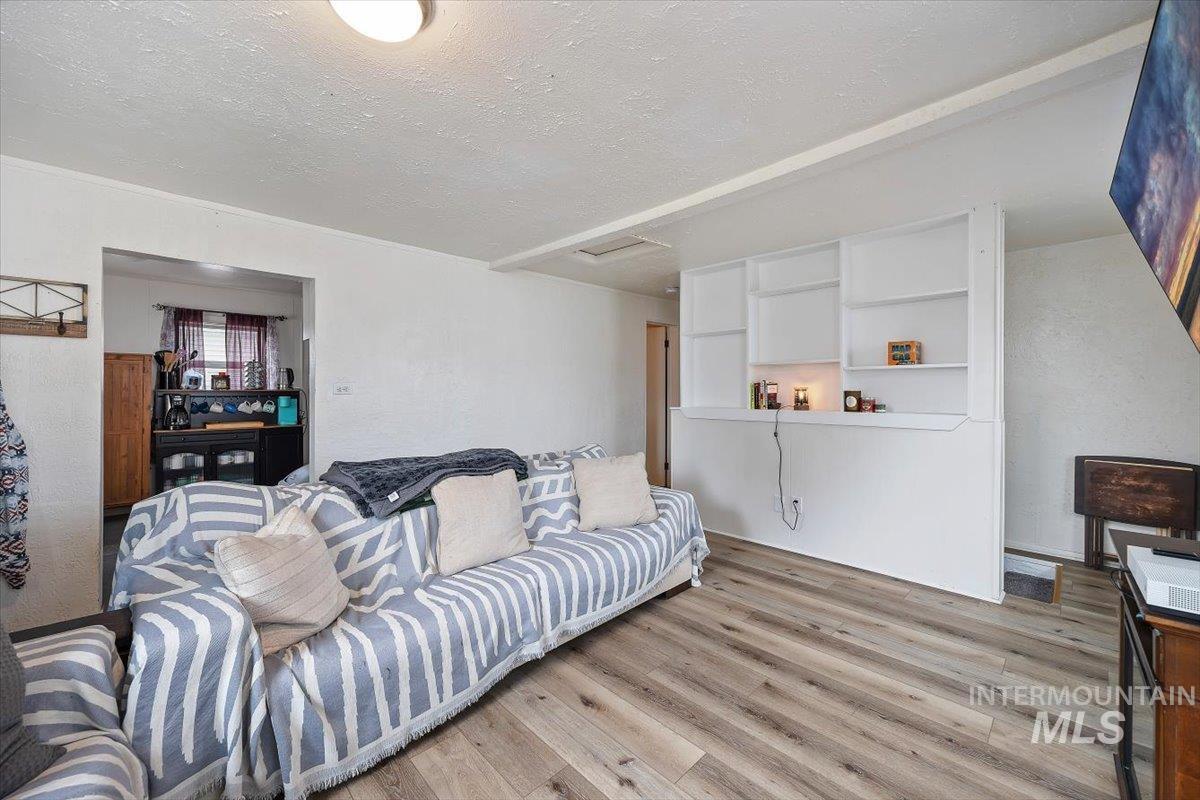 347 Polk Street Twin Falls, ID 83301 - Photo 8 of 25 Living room with light wood-style floors, a textured ceiling, and a textured wall