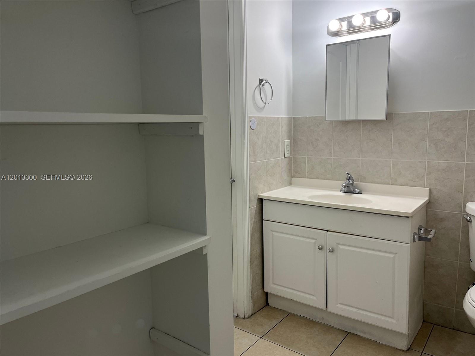1020 Southwest 4th Street, Unit 102 Miami, FL 33130 - Photo 12 of 14 a bathroom with a sink and a mirror