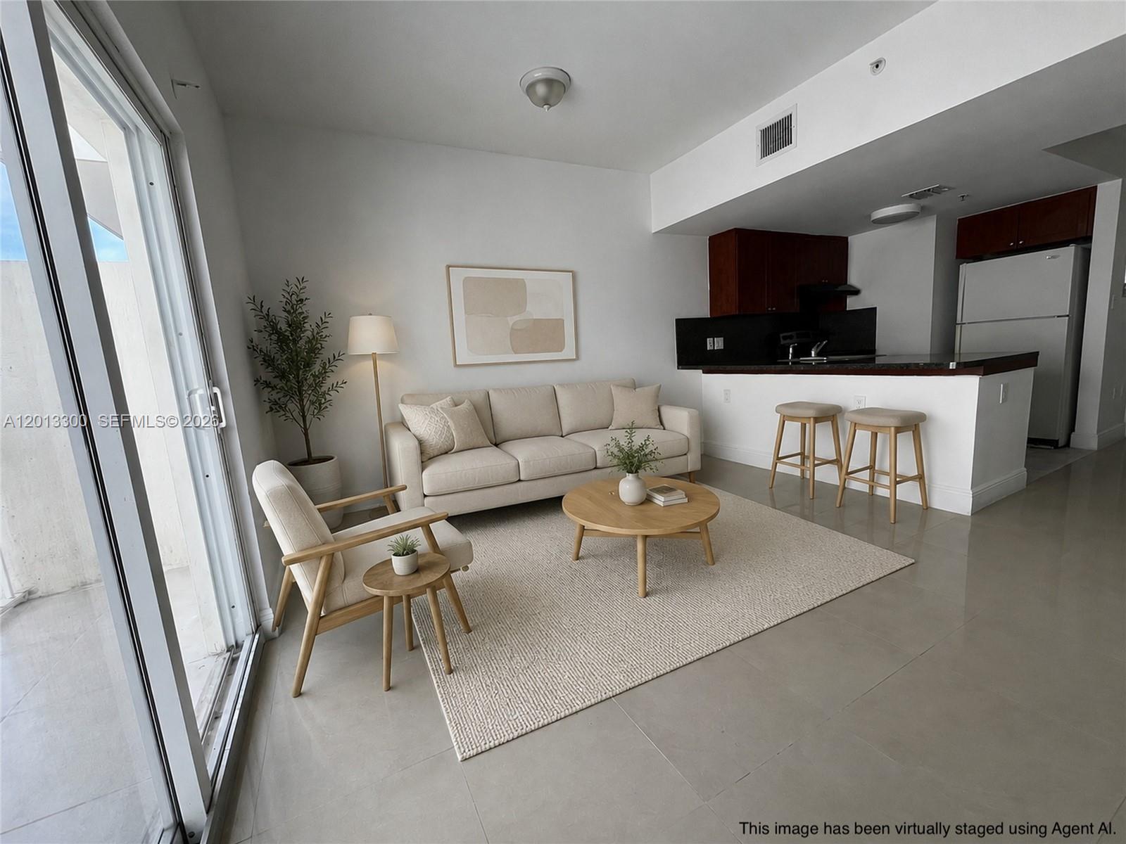 1020 Southwest 4th Street, Unit 102 Miami, FL 33130 - Photo 2 of 14 a living room with furniture and a flat screen tv