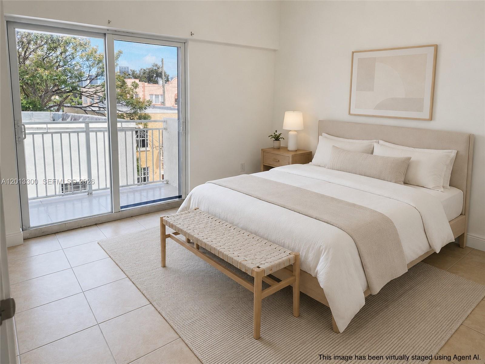 1020 Southwest 4th Street, Unit 102 Miami, FL 33130 - Photo 7 of 14 a spacious bedroom with a bed and large window