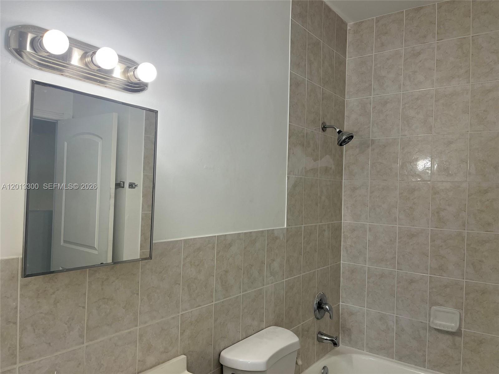 1020 Southwest 4th Street, Unit 102 Miami, FL 33130 - Photo 10 of 14 a bathroom with a toilet a sink and shower
