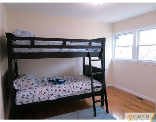 10 James Road East Brunswick, NJ 08816 - Photo 8 of 15 a bedroom with a bed and wooden floor