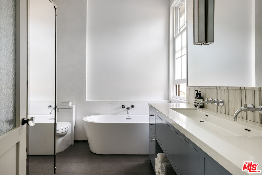 461 West Rustic Road Santa Monica, CA 90402 - Photo 26 of 31 a bathroom with a double vanity sink tub and mirror