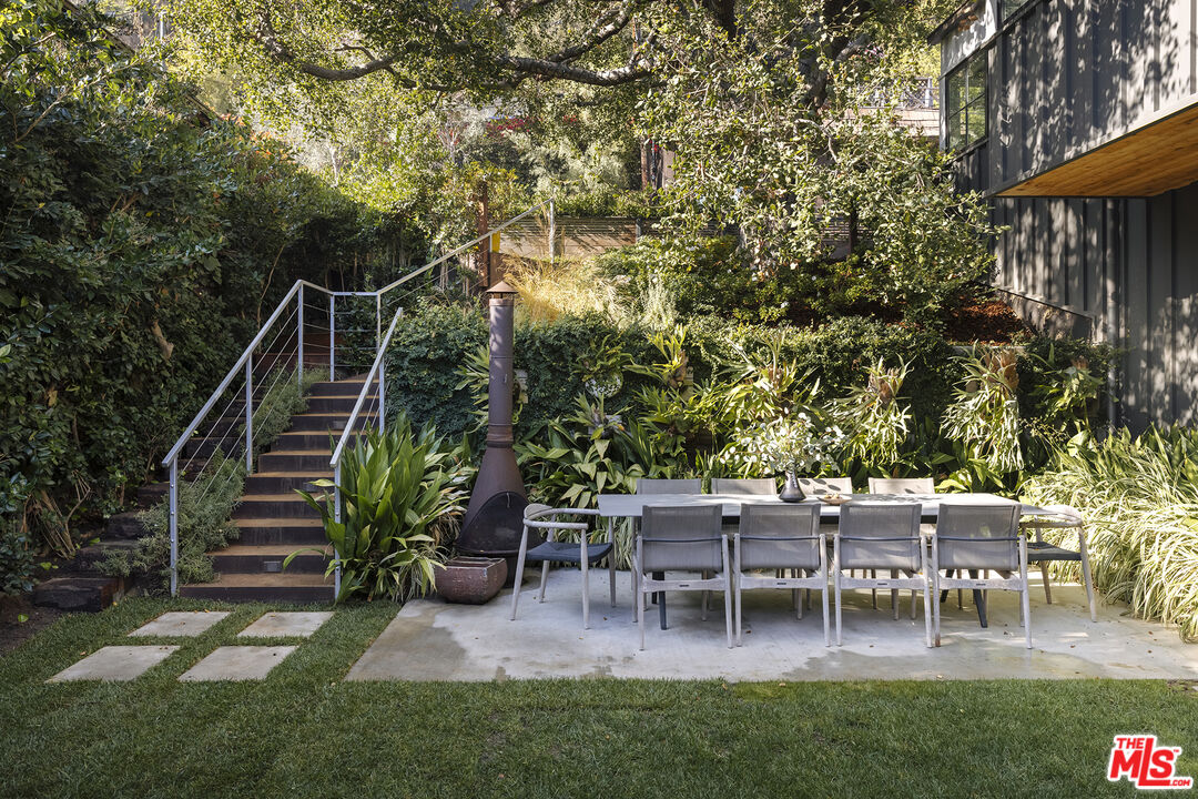 461 West Rustic Road Santa Monica, CA 90402 - Photo 28 of 31 a view of a chairs and table in backyard of the house
