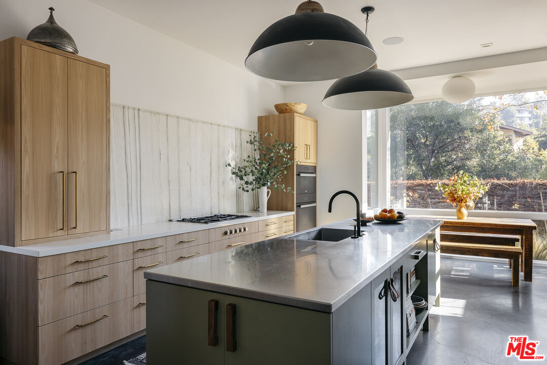 461 West Rustic Road Santa Monica, CA 90402 - Photo 8 of 31 a kitchen with stainless steel appliances a sink a stove and a window
