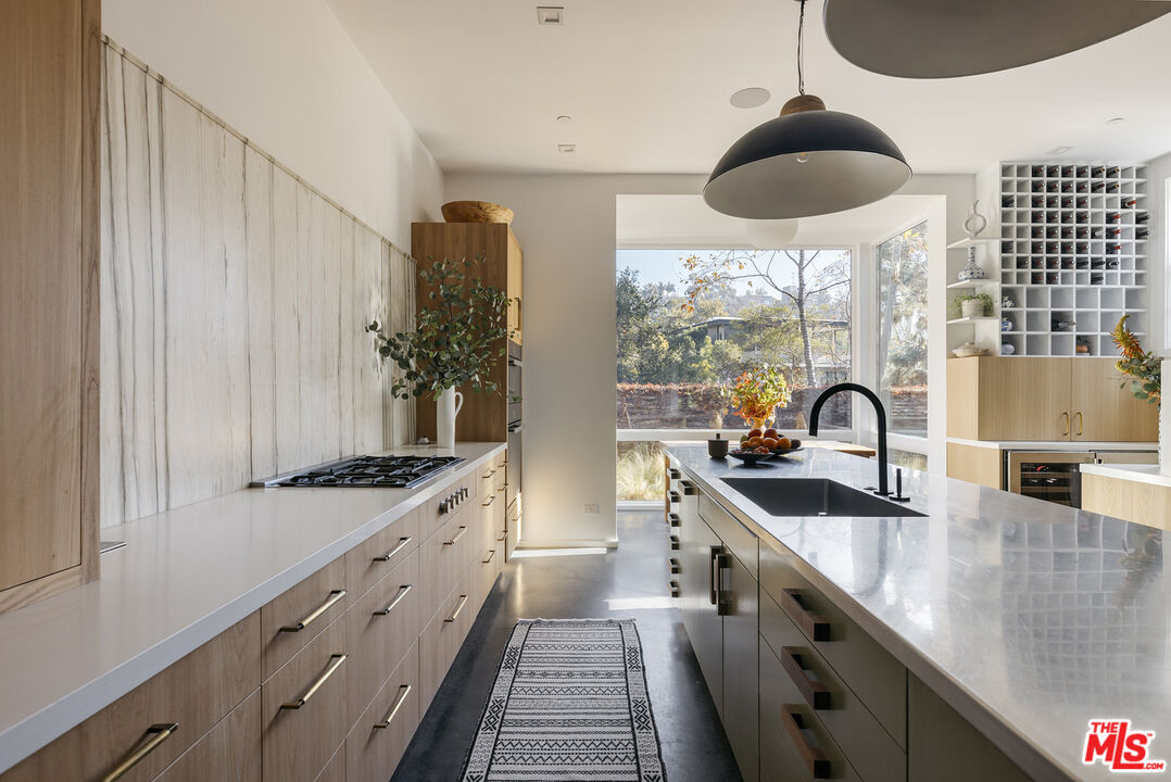 461 West Rustic Road Santa Monica, CA 90402 - Photo 9 of 31 a kitchen with stainless steel appliances a sink a stove and a window