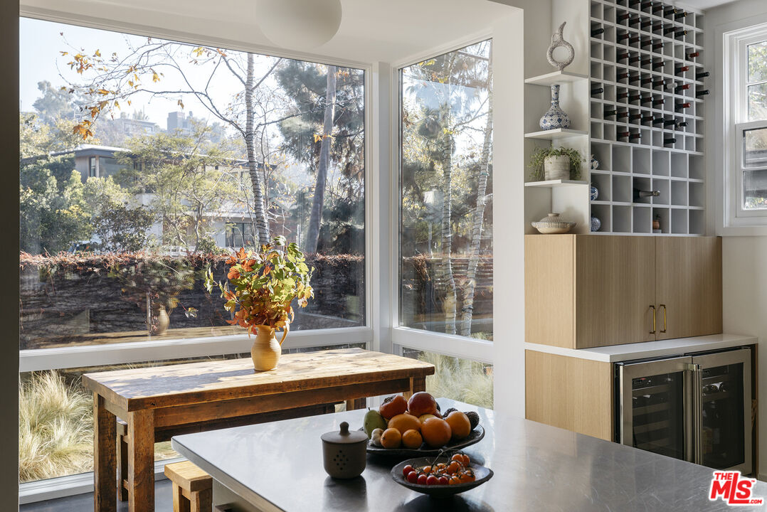 461 West Rustic Road Santa Monica, CA 90402 - Photo 10 of 31 a table with a vase and flowers on it
