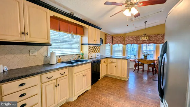a living room with furniture a window and kitchen view
