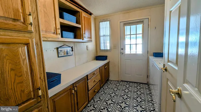 a bath room with a granite countertop toilet a sink and a tub