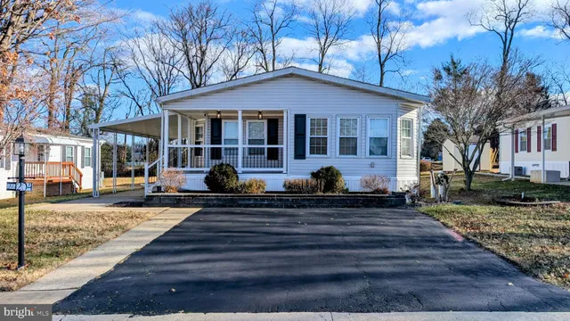 a front view of a house with yard and green space