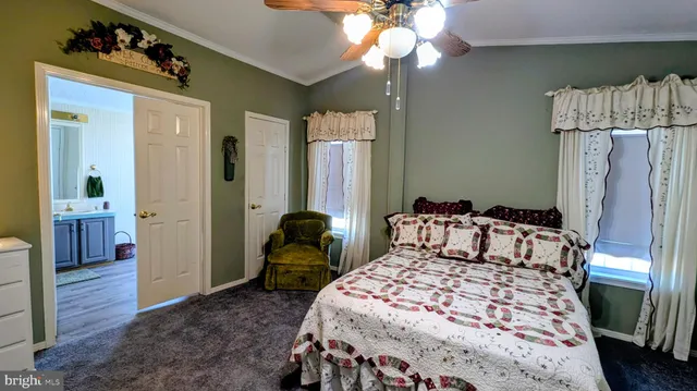 a bedroom with a bed couch and window