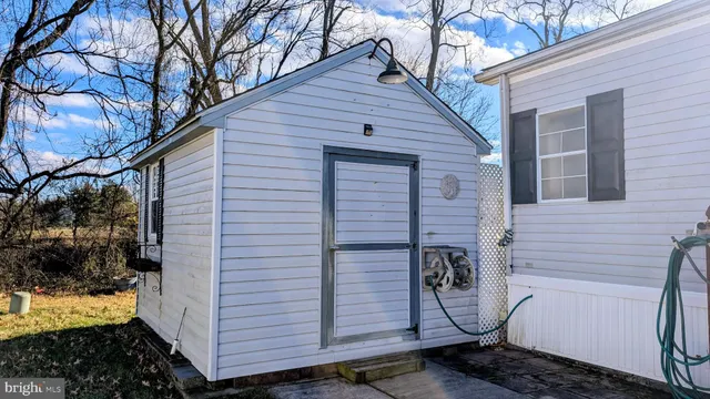a view of a door and chair in a hallway