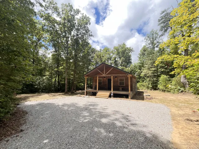 a view of a house with a yard covered with snow in the background