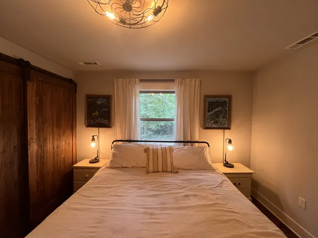 a bedroom with a bed and a window