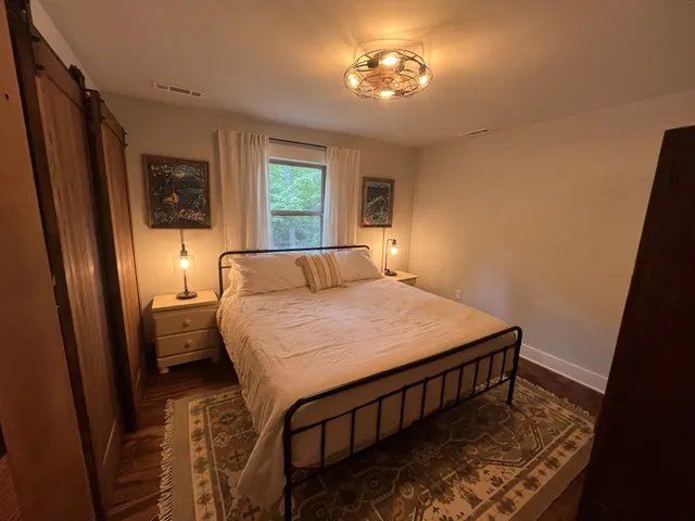 a bedroom with a bed and a window