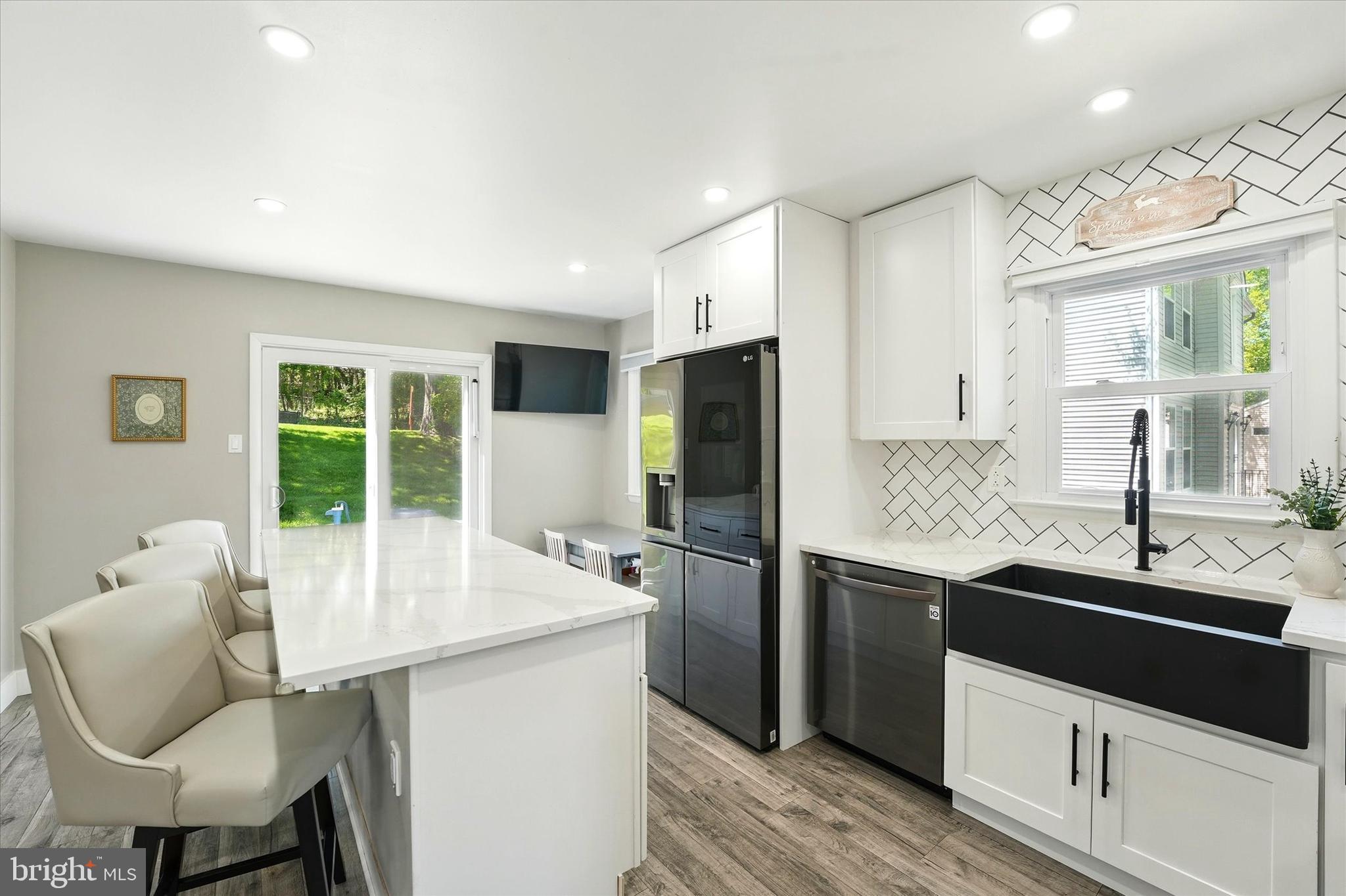 237 Bridge Road Upper Chichester, PA 19061 - Photo 7 of 27 a kitchen with refrigerator and chairs