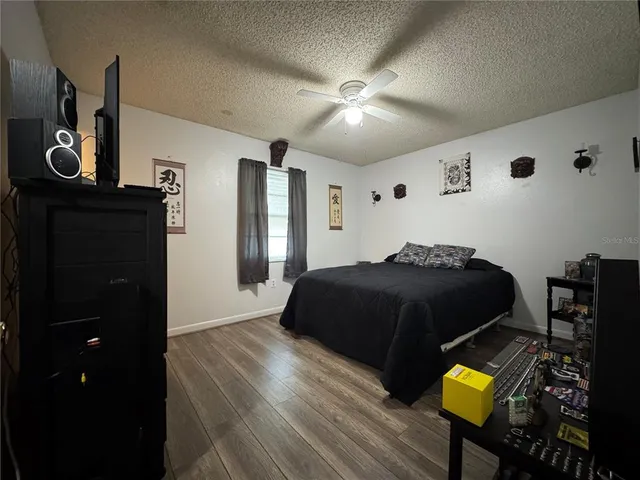 a bedroom with a bed and painting on the wall