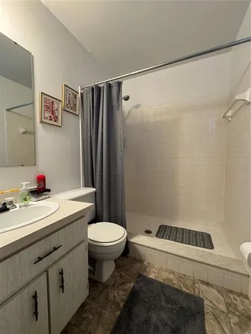 a bathroom with a sink toilet and shower