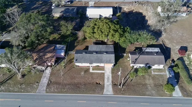 an aerial view of a house with garden space and street view