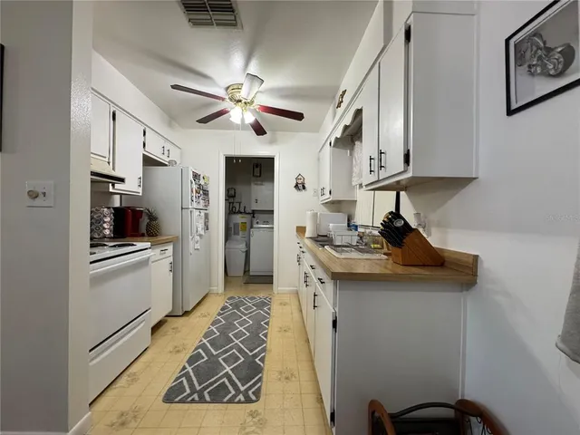 a kitchen with stainless steel appliances a sink stove and refrigerator