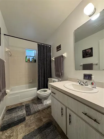 a bathroom with a double vanity sink toilet and shower