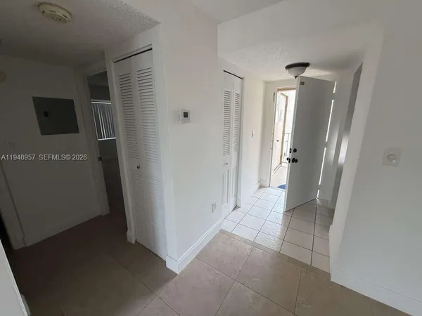 a view of a room with wooden floor and window