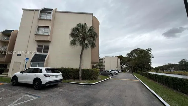 a car parked beside a road next to a building